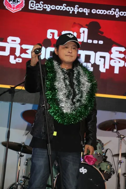 Under the bright lights of Adelaide in April 2024, singer and Academy Award-winning actor Min Maw Khun took the stage at a fundraising concert—not just to perform, but to make a statement. Once a celebrated artist in Myanmar, he became a symbol of resistance when he stood with the Spring Revolution. His defiance came at a cost—his home was seized by the military, forcing him to flee into the depths of the jungle, navigating the perilous path to the Myanmar-Thailand border. Now, finding refuge in Australia with his family, he continues his fight, using his voice not only for music but for a cause far greater than himself.