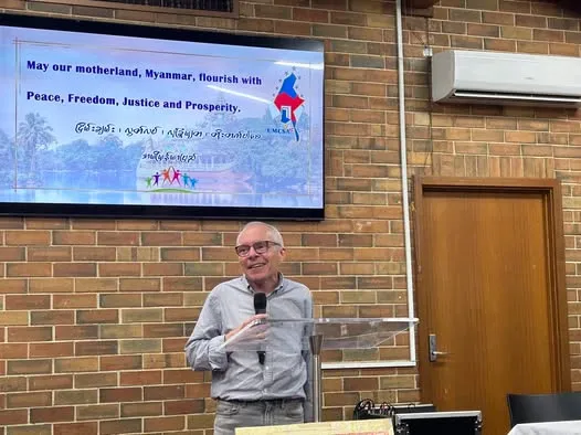 Professor Sean Turnell, an Australian economist and former economic advisor to Daw Aung San Suu Kyi, was imprisoned by the military on February 1, 2021, during the coup in Myanmar. After being detained for nearly two years, he was released from prison in November 2022. A respected expert in his field, he has served as an honorary professor of economics at Macquarie University, a former staff member of the Reserve Bank of Australia, and the director of research at the Myanmar Development Institute. This photo was taken during his Australia tour for the release of his book Unlikely Prisoner, which chronicles his harrowing experience in detention and his unwavering commitment to Myanmar's future.