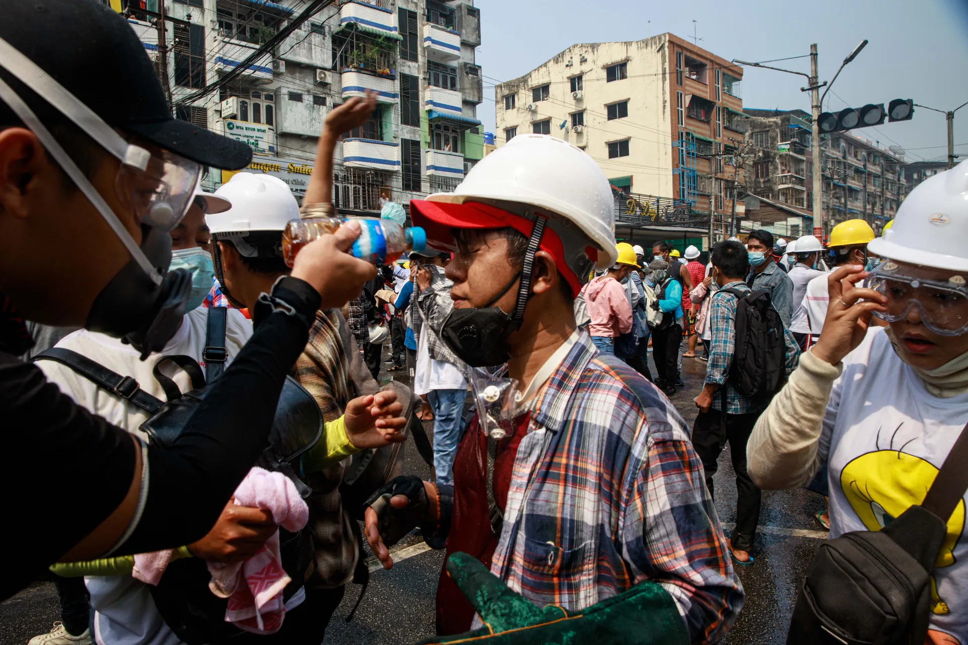 A young protester receives aid from his friends as they wash his face after he was affected by tear gas grenades fired by the military during an anti-coup rally in Yangon. The moment captures the resilience and solidarity among demonstrators amid the crackdown. Photo - TaMwe